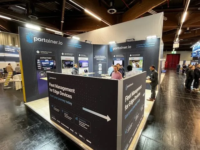 Partner booth on industrial IoT and fleet management at SPS Nuremberg 2024 with visitors at the counter.